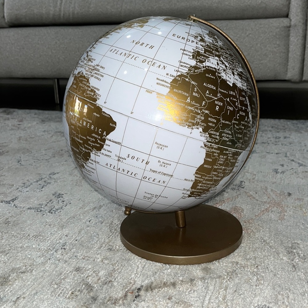 White and gold world globe